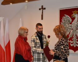 Przewodniczący Rady Gminy wręcza kwiaty nauczycielowi